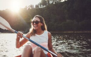 Woman in Canoe Smiling About Dental Crowns and Bridges from Hillsboro Dental Excellence