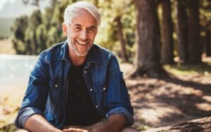Man Outside Smiling with Porcelain Veneers from Hillsboro Dental Excellence