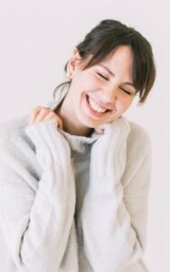 Happy Woman Learns What Dental Veneers Are from Hillsboro Dental Excellence