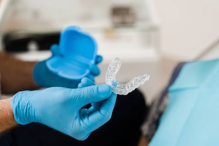 A dentist showing Invisalign clear aligners.