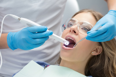 A female is having her gum disease treatment at our dental clinic.