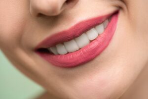 Woman's smiling lips with pink lipstick