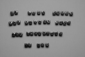 Motivational message with letter beads on gray
