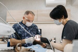 Dentist performing procedure with dental assistant