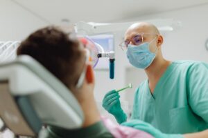 Dentist examining patient in dental clinic