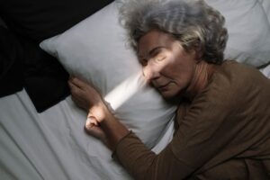 Elderly woman peacefully sleeping on pillow