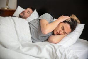 Woman disturbed by partner's snoring in bed