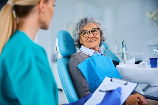 Senior dental patient discussing full mouth rehabilitation with a dentist during a free consultation for full mouth reconstruction in Oregon.