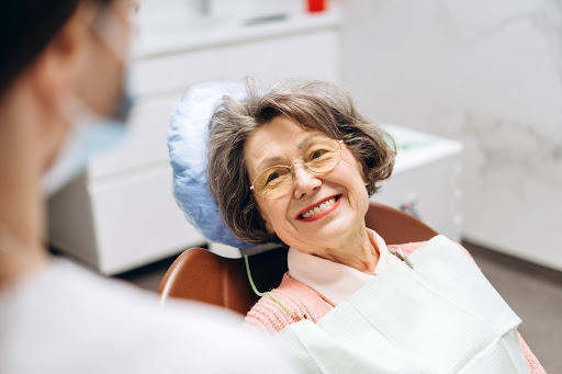 Smiling elderly patient during a teeth restoration consultation at Hillsboro Dental Excellence for full mouth restoration treatment.