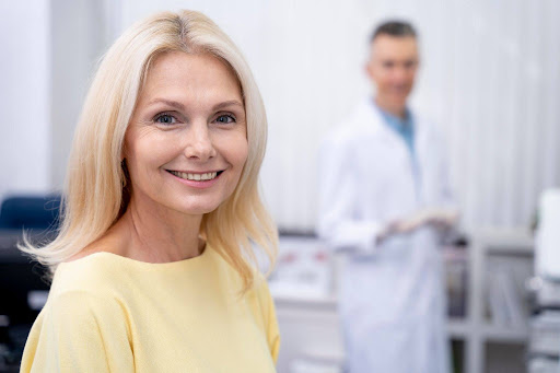 Happy female patient smiling during a dental reconstruction cost consultation.