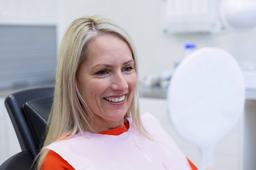 Happy dental patient smiling during restoration dental consultation at Hillsboro Dental Excellence.